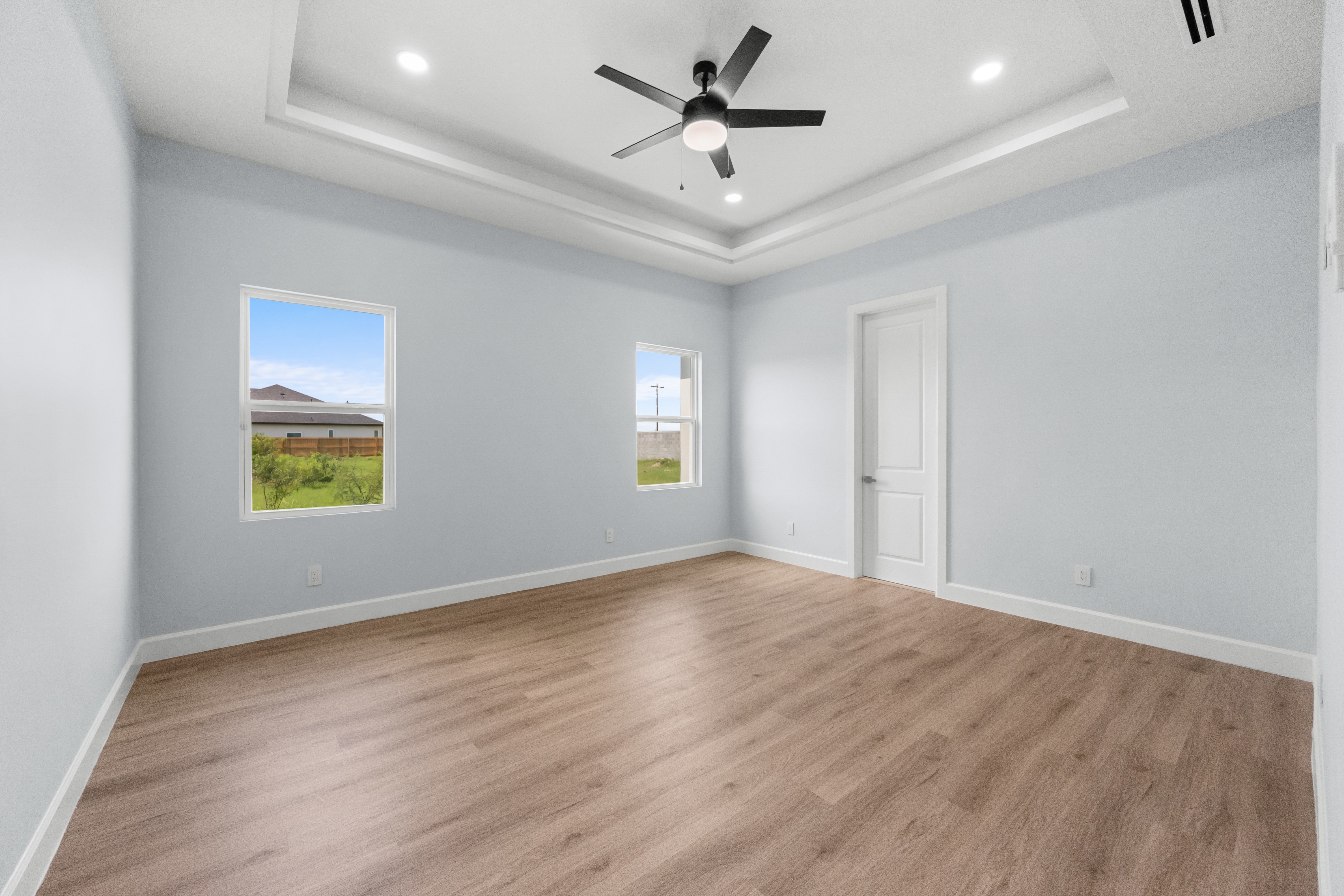 Primary bedroom with tray ceiling