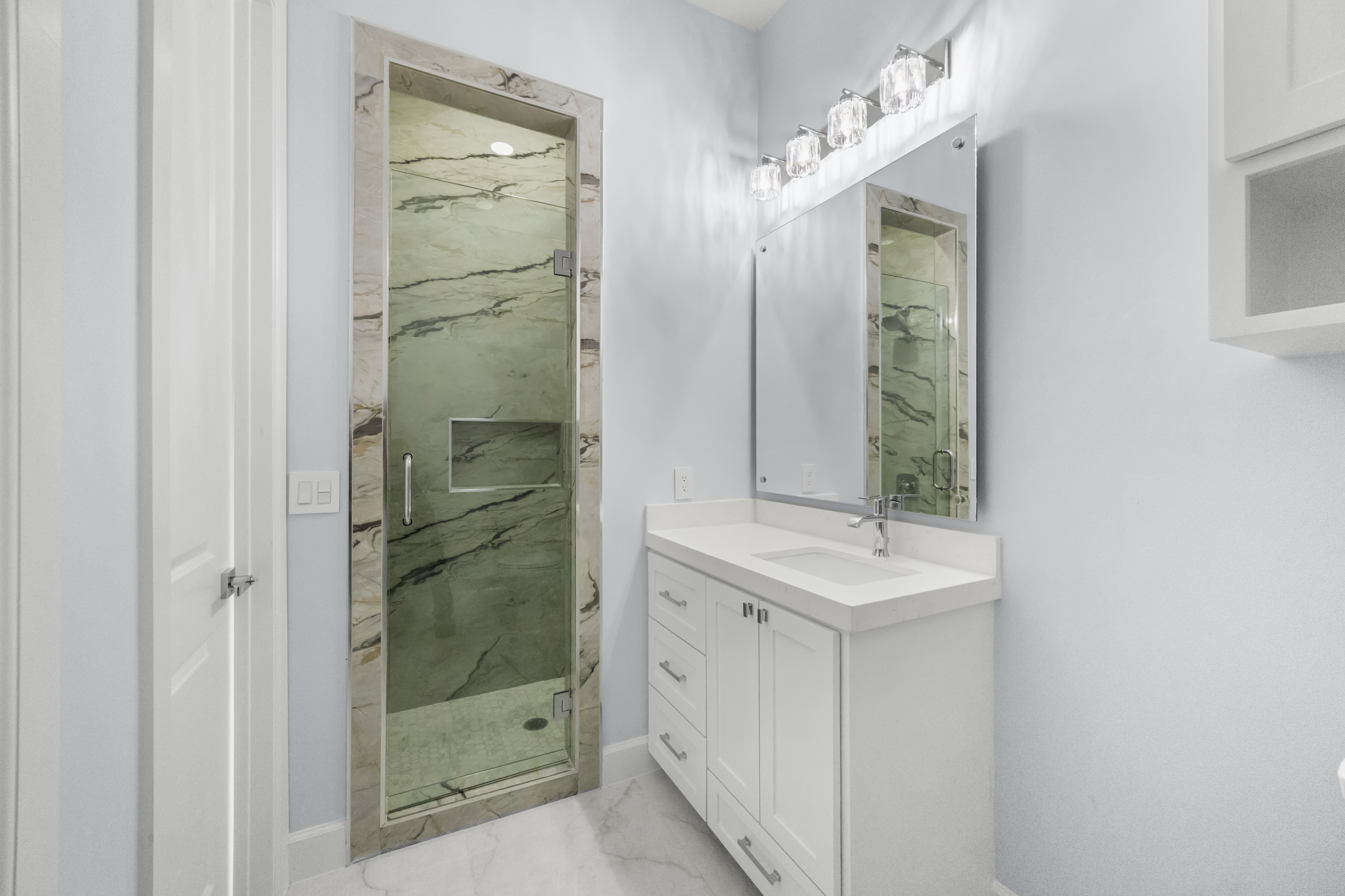 Guest bath with green marble shower