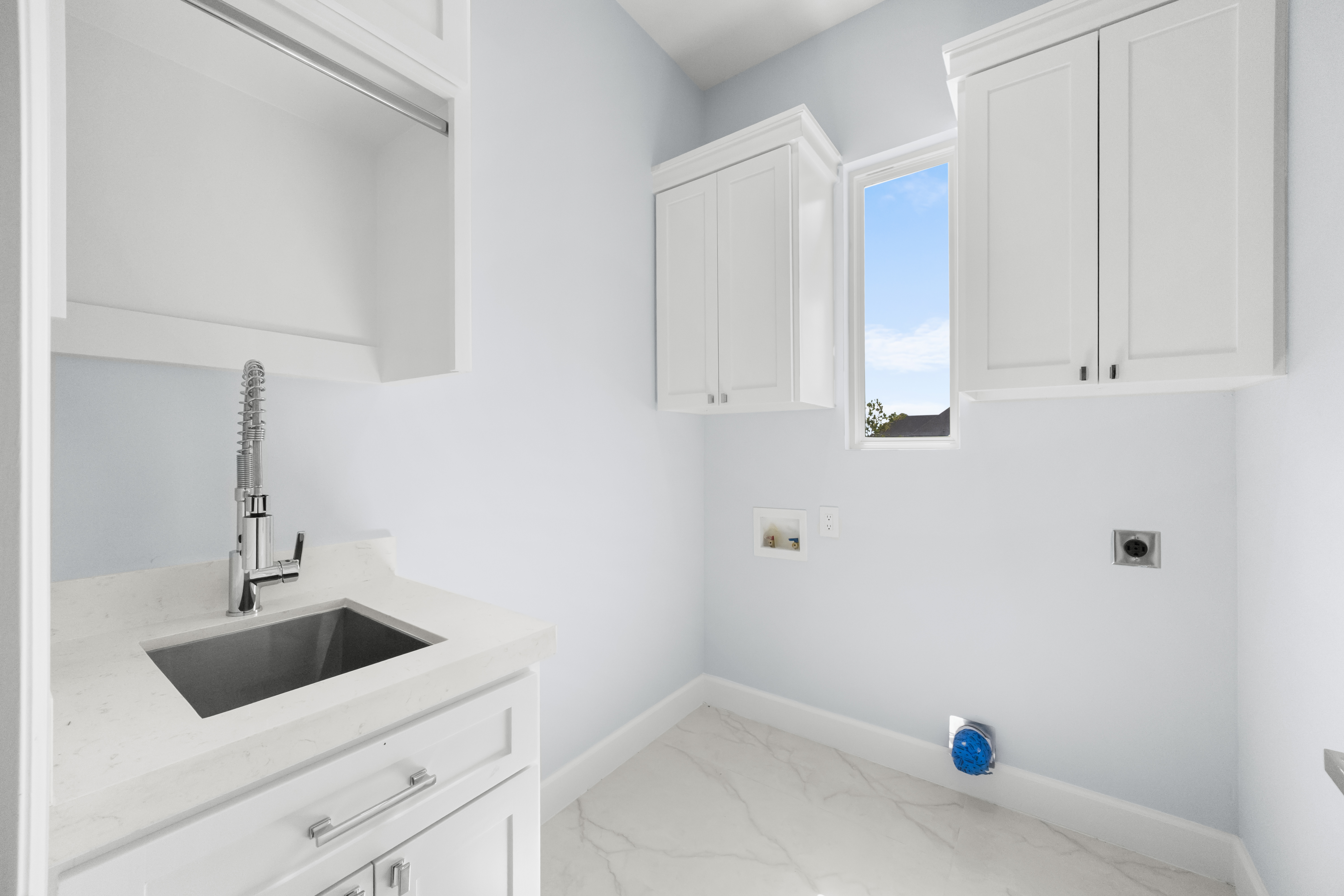 Laundry room with utility sink and hookups